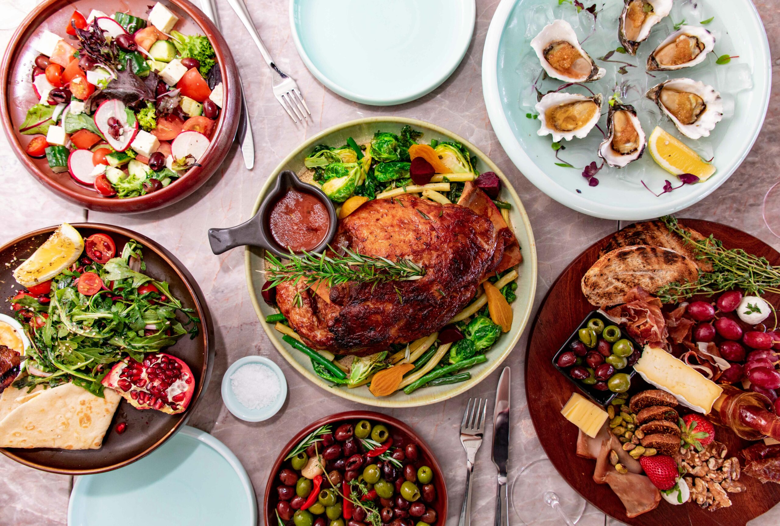 Top view of a gourmet feast featuring various dishes, salads, and seafood for an elegant dining experience.